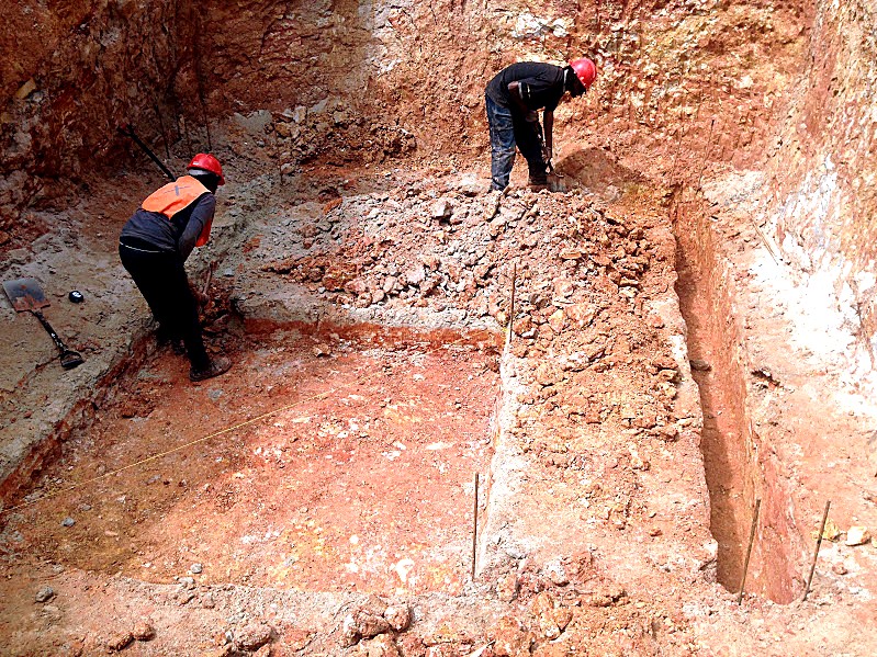 Hand-dug foundation trenches with steel reinforcing on a Conceptial site